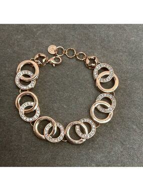 Absolute rose gold tone circular interlocking chain-link rhinestone bracelet
